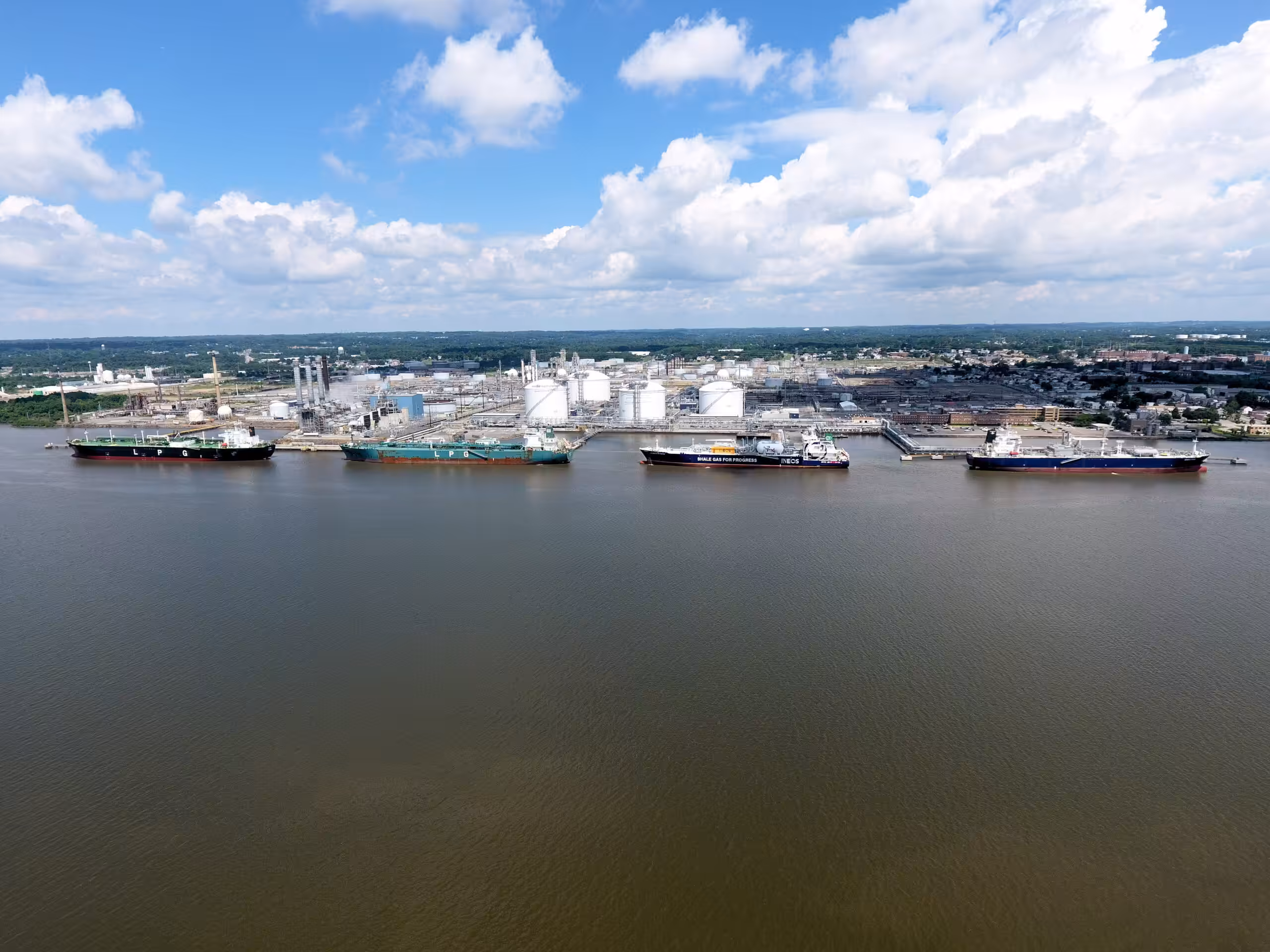 An aerial view of several ships docked in a body of water.
